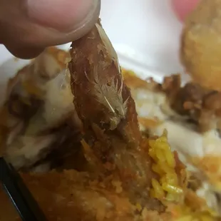 a person dipping a piece of fried food