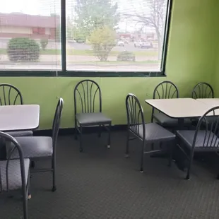 a dining area with tables and chairs
