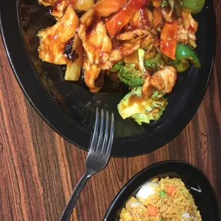 a plate of chinese food and a bowl of rice