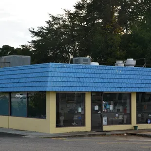 a yellow building with a blue roof