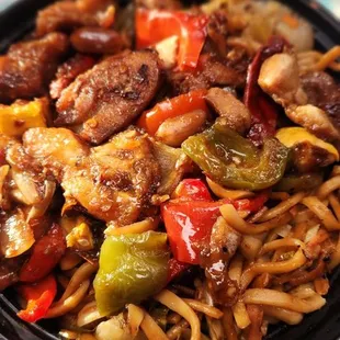 a plate of noodles with meat and vegetables