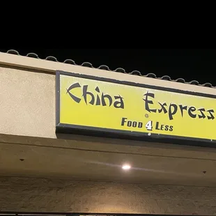 a yellow sign on the side of a building