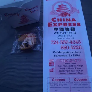 a box of chinese food and a receipt on a table