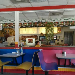 a restaurant with colorful booths and tables