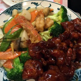 Dragon and Phoenix - divided plate of assorted vegetables with lobster, shrimp sauteed in a spicy white sauce and chicken chunks fried