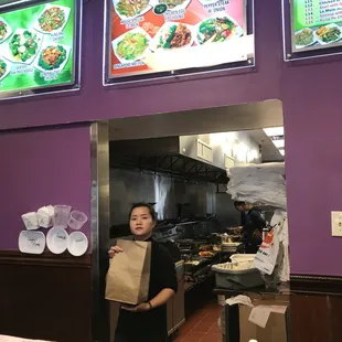 a woman holding a bag of food