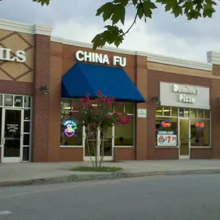 a storefront with a blue awning