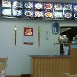 a man standing at a counter in a restaurant