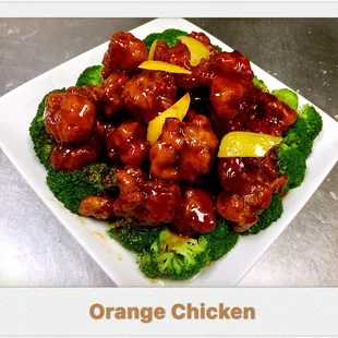 a plate of orange chicken with broccoli