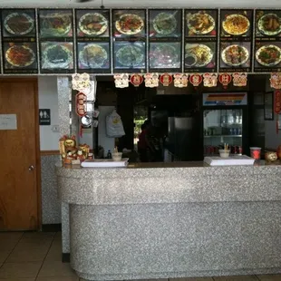 a restaurant counter with a lot of food on it