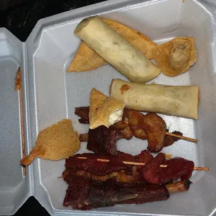 a variety of food in a styrofoam container