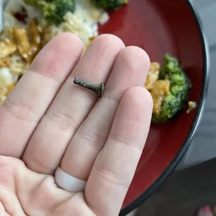 a person&apos;s hand holding a tiny piece of food