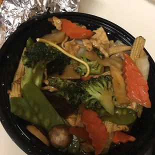 The chicken veg medley you are supposed to eat on top of the big block of fried noodles.