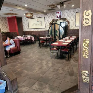 Inside of restaurant from entranceway.  More tables along left and right wall.