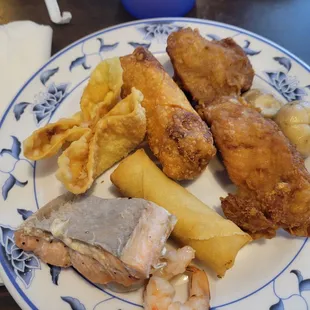 Salmon, shrimp, spring roll, egg roll, crab Rangoon, and chicken on a stick.