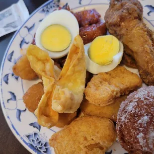 Chicken nuggets, crab Rangoon, drumstick, boiled egg, and sugar donut.