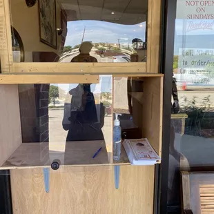 a person taking a selfie through a window