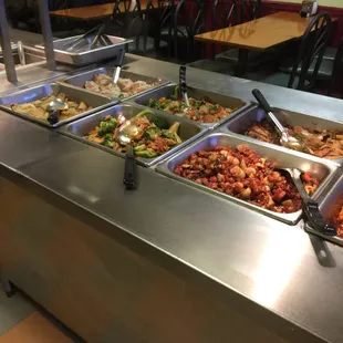 a variety of food being served at a buffet