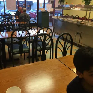 a young boy sitting at a table in a restaurant