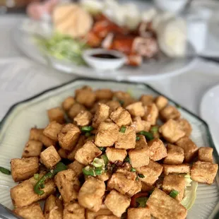 a plate of fried tofu on a table