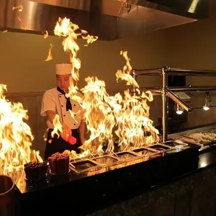 a chef preparing food on fire