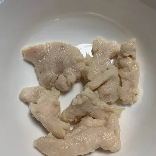 a plate of raw chicken breasts