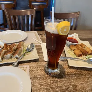 a glass of tea and plates of food