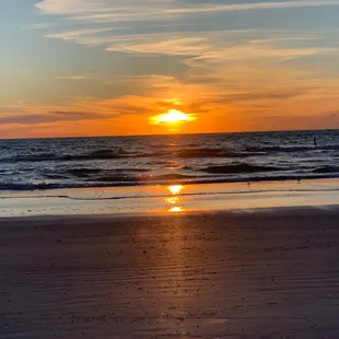 the sun setting over the ocean