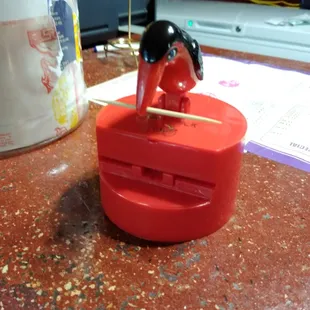 I think this is the cutest little too toothpick dispenser I've ever seen. Push down on the bird's head and he takes a tooth pick out lol.