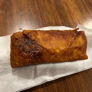 a pastry on a napkin on a wooden table