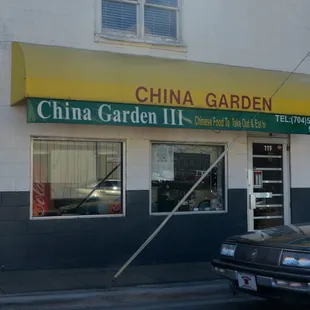 a car parked in front of a chinese garden