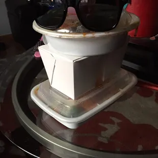 a pair of sunglasses on top of a toilet