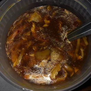 a bowl of stew with a spoon in it