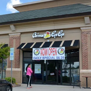 a woman walking in front of a store