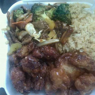 a tray of food with rice, meat, and vegetables