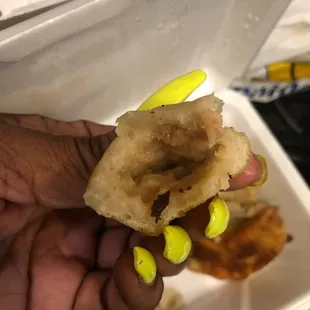 a hand holding a piece of food