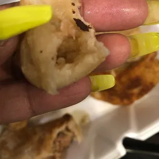 a hand holding a piece of food