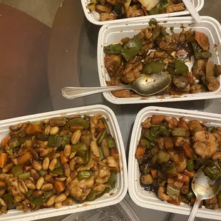 four containers of food on a table