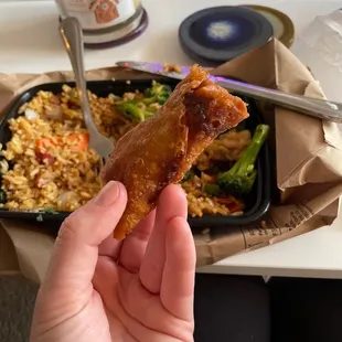 a person holding a piece of food