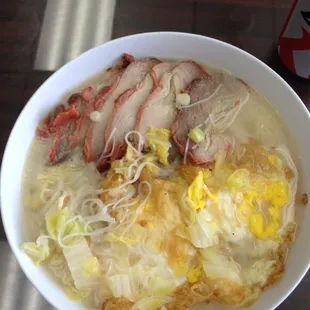 a bowl of soup with meat and noodles