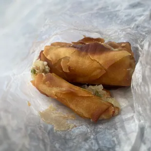 a piece of food wrapped in wax paper