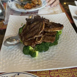 a plate of meat and broccoli