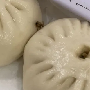 two dumplings in a plastic container