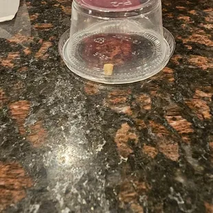 a plastic container on a granite countertop