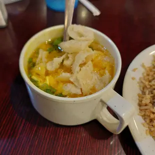 a bowl of soup and a plate of rice