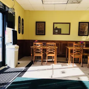 a dining area with tables and chairs