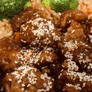 a plate of meatballs, rice, and broccoli
