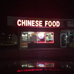 a chinese food restaurant lit up at night