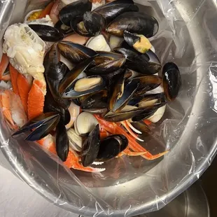 a bowl of seafood and crab legs