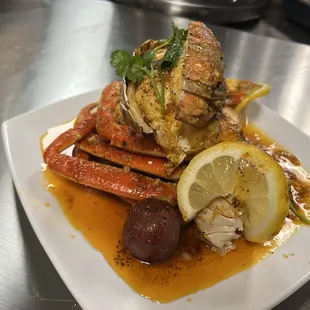 a plate of crab legs with a lemon wedge